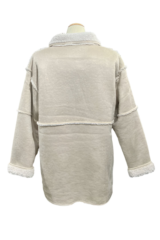 Beige jacket on a mannequin in a store setting