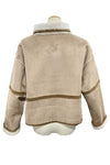 Beige jacket with brown trim on a mannequin in a store setting