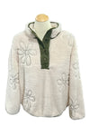 White textured jacket with floral patterns on a mannequin in a store setting