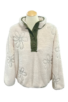  White textured jacket with floral patterns on a mannequin in a store setting