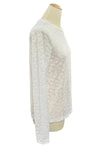 White textured sweater on a mannequin in a store setting