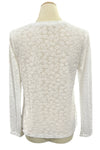 White textured sweater on a mannequin in a store setting
