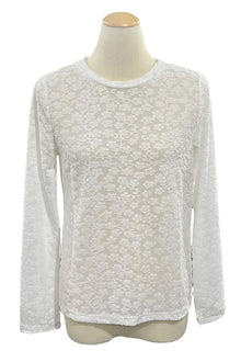  White long-sleeve shirt on a mannequin in a store setting