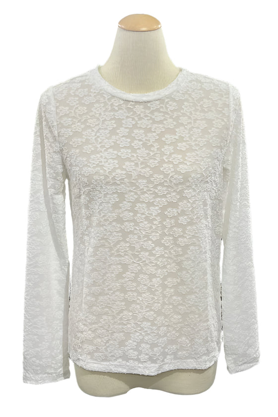 White long-sleeve shirt on a mannequin in a store setting