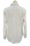White shirt on a mannequin against a blurred indoor background