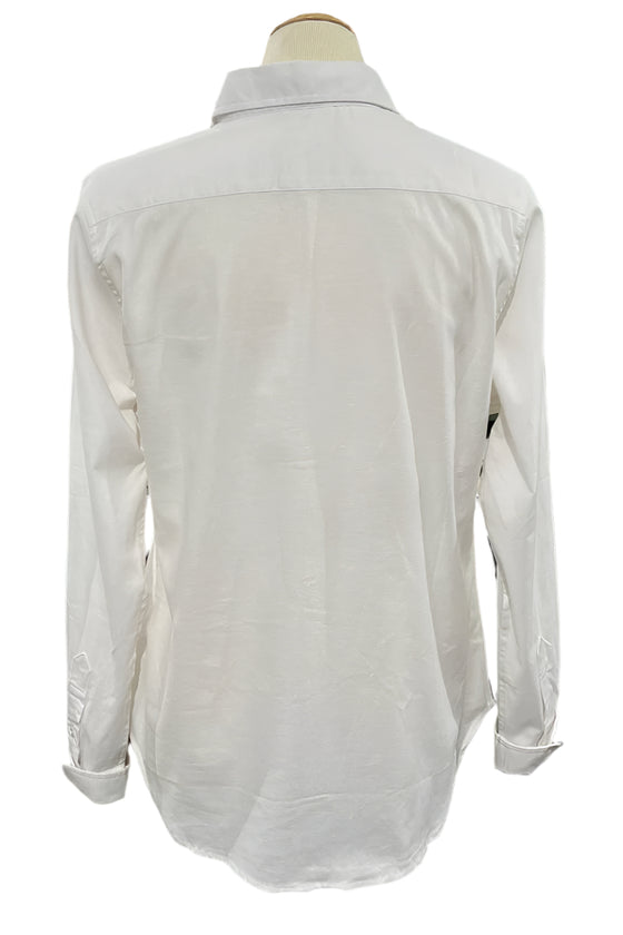 White shirt on a mannequin against a blurred indoor background