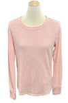 Pink long-sleeve shirt on a mannequin in a store setting