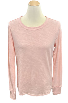 Pink long-sleeve shirt on a mannequin in a store setting