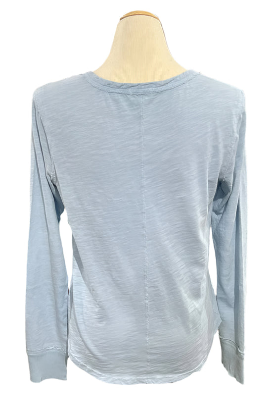 Light blue long-sleeve shirt on a mannequin in a store setting