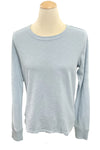 Light blue long-sleeve shirt on a mannequin in a store setting