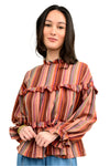Woman wearing a striped blouse with ruffled details on a white background