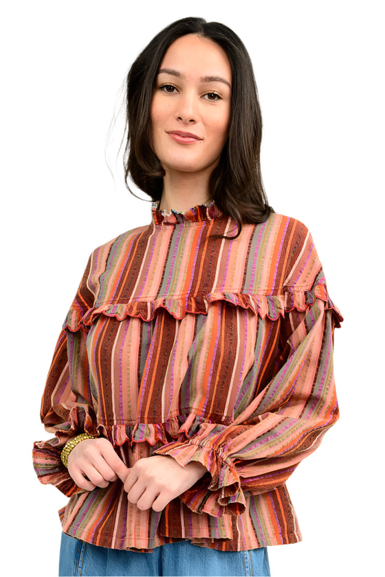 Woman wearing a striped blouse with ruffled details on a white background