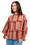 Woman wearing a striped blouse with ruffled details on a white background