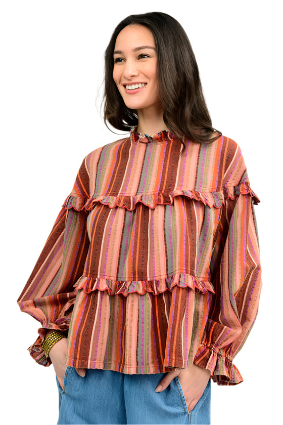 Woman wearing a striped blouse with ruffled details on a white background