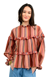  Woman wearing a striped blouse with ruffled details on a white background