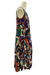 Colorful abstract patterned dress on a mannequin against a white background