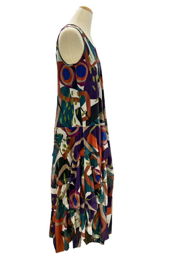 Colorful abstract patterned dress on a mannequin against a white background