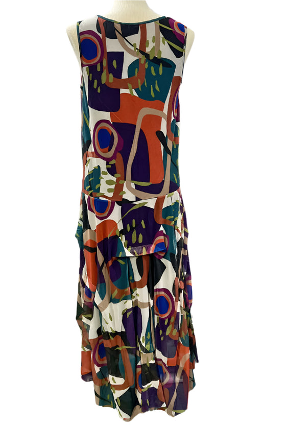 Colorful abstract patterned dress on a mannequin against a white background