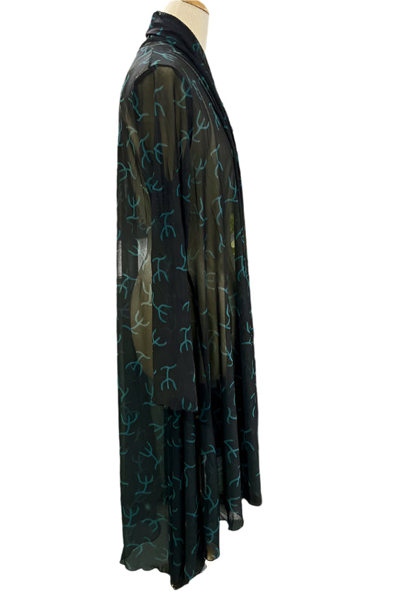 Black dress with green floral pattern on a mannequin against a white background
