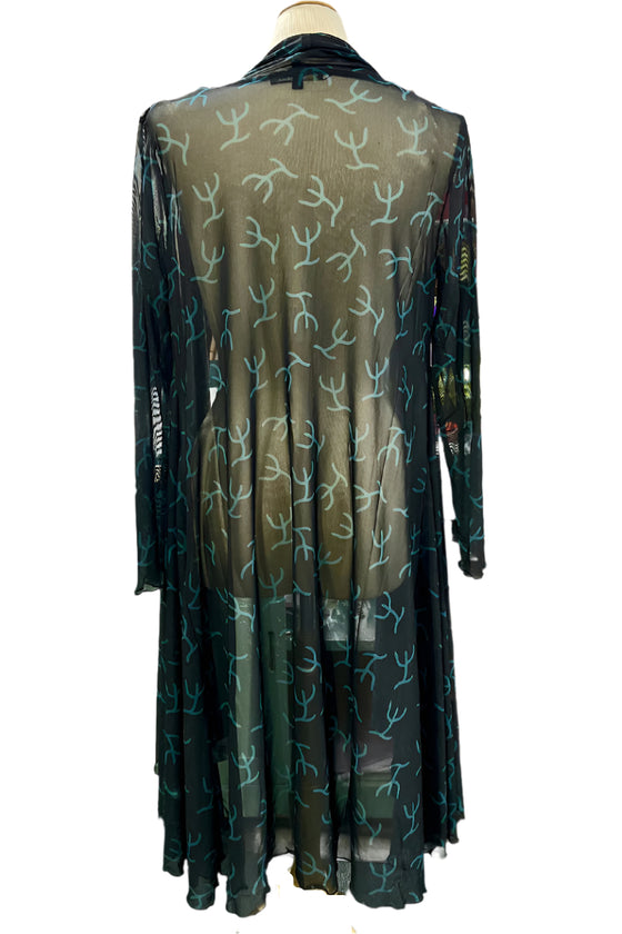 Long, dark green dress with light green patterns on a mannequin against a white background