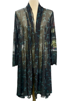  Black sheer cardigan with white floral pattern on a mannequin against a blurred outdoor background