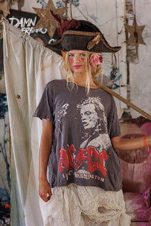  Person wearing a pirate hat and AC/DC t-shirt in a rustic setting