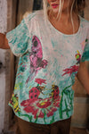 Person wearing a colorful t-shirt with artistic designs and text.