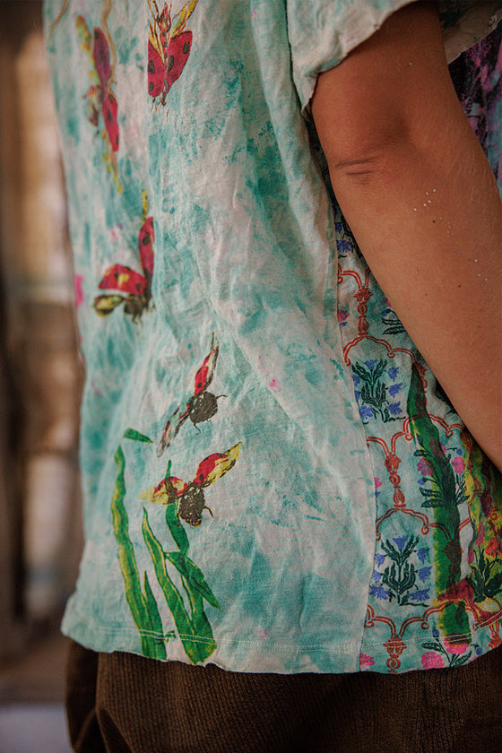 Close-up of a colorful shirt with butterfly designs on a blurred background