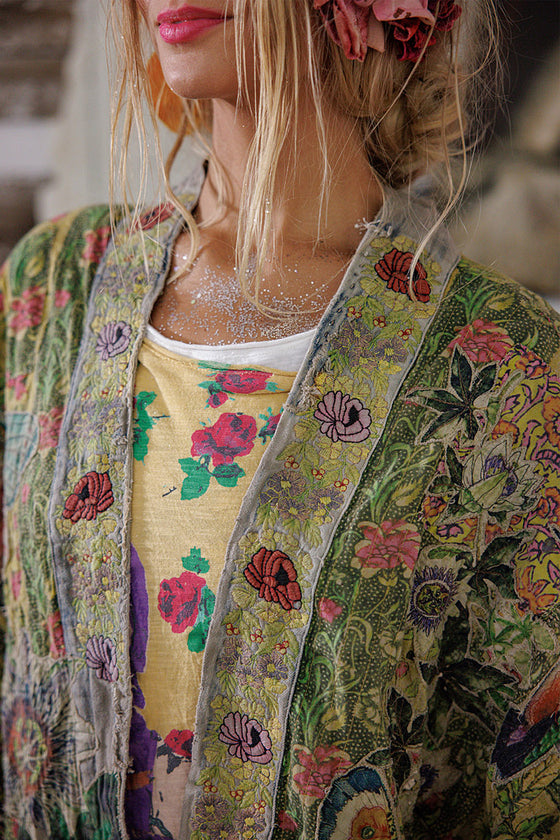 Woman wearing a colorful floral jacket with a blurred background