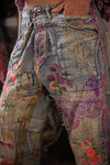 Close-up of embellished jeans with floral and butterfly patterns.
