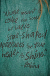 Text on a teal fabric with a quote by Robina