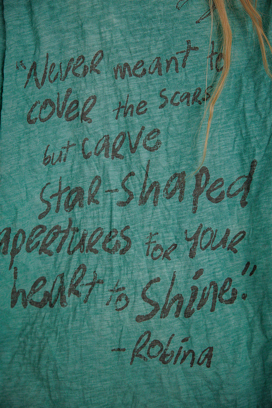 Text on a teal fabric with a quote by Robina