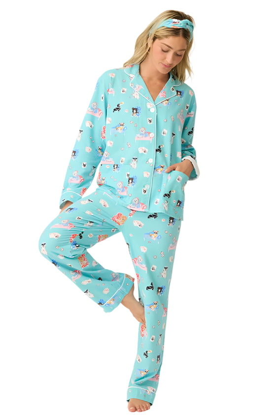 Woman wearing a light blue pajama set with animal print on a white background