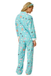 Woman wearing a turquoise pajama set with animal print on a white background