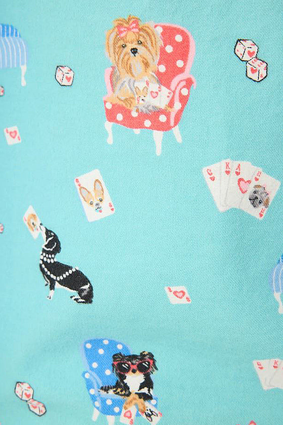 Pattern of dogs and playing cards on a blue background
