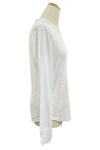 White long-sleeve shirt on a mannequin in a store setting