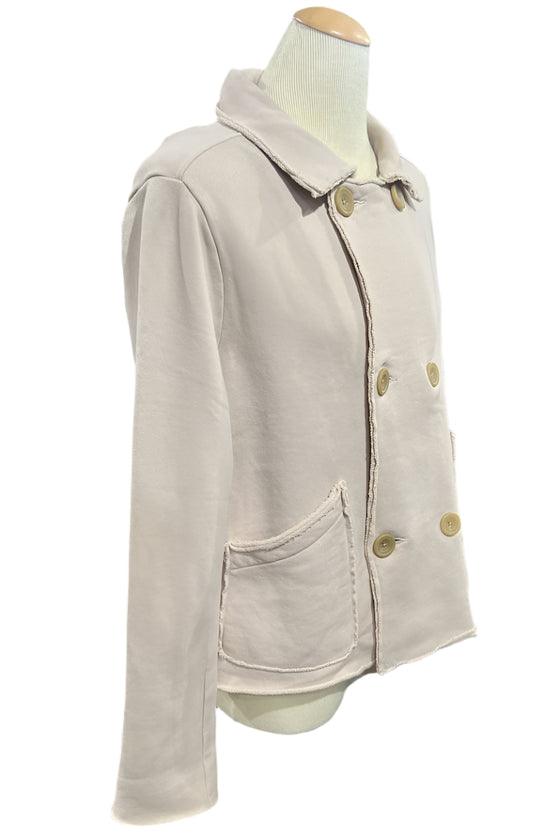 Beige jacket on a mannequin in a store setting