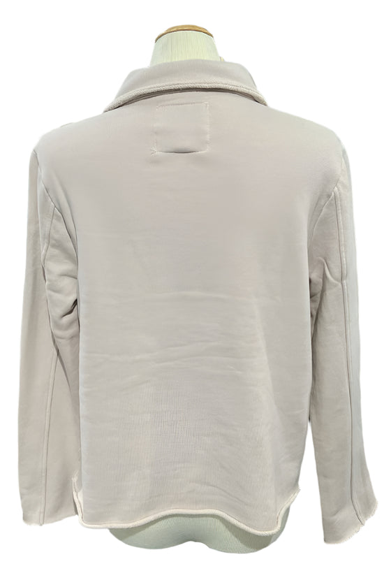 Beige fleece jacket on a mannequin in a store setting
