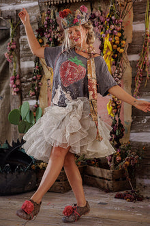  Person in a rustic setting with floral decorations and a cactus plant.