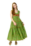 Woman wearing a green dress with floral embroidery on a white background