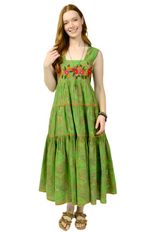  Woman wearing a green dress with floral embroidery on a white background