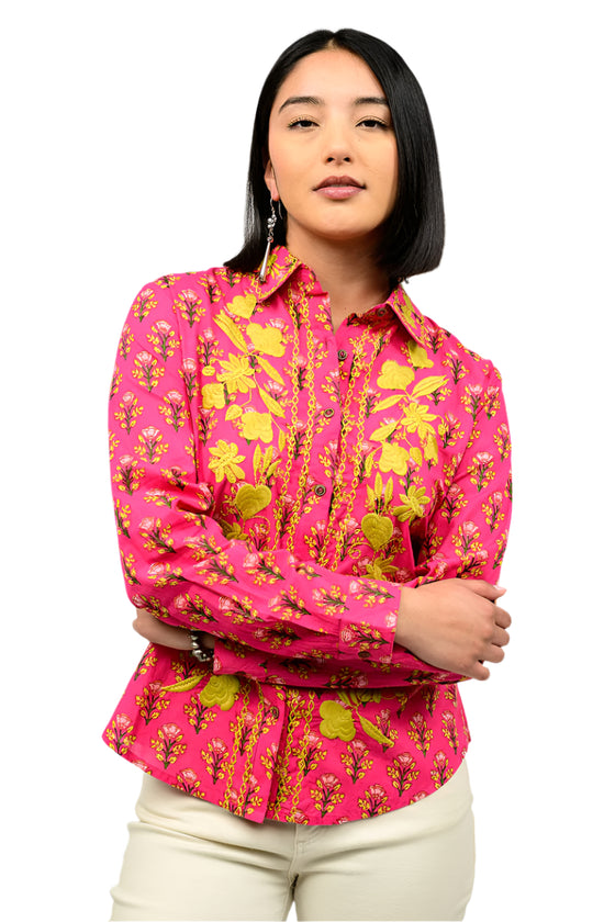 Woman wearing a pink floral blouse against a white background