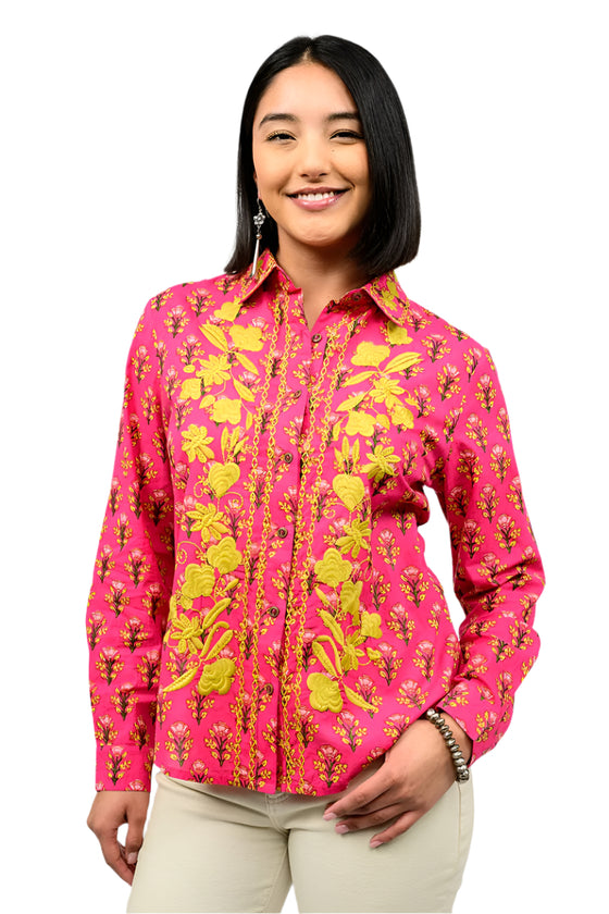 Woman wearing a pink floral shirt against a white background
