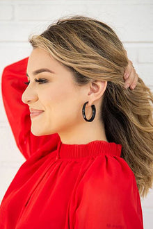  Woman wearing a red top with a blurred background