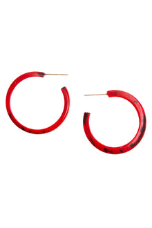  Red hoop earrings with black speckles on a white background