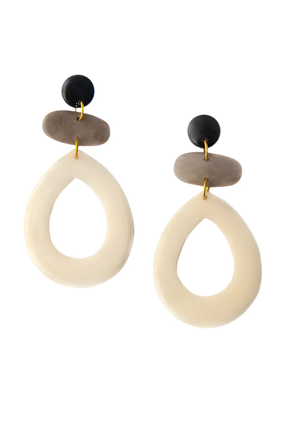 Pair of earrings with beige teardrop shapes, black and gold accents on a white background