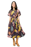 Woman wearing a patterned dress with a plain background