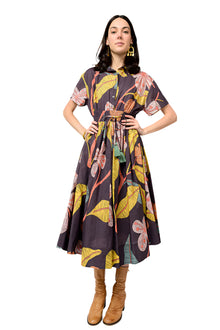  Woman wearing a patterned dress with a plain background