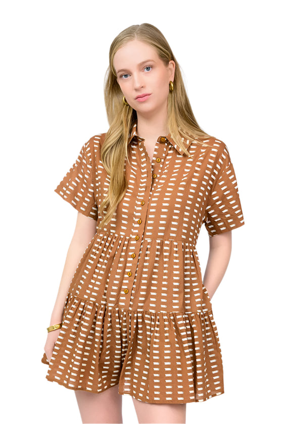 Woman wearing a brown patterned romper on a white background