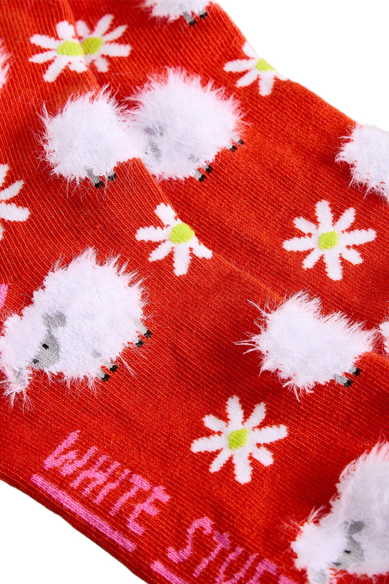 Red sock with white hedgehogs and flowers pattern, brand 'White Stuff' visible.